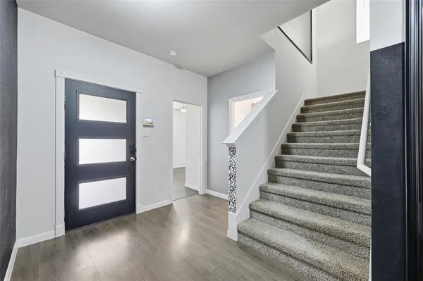 a view of an entryway with wooden floor