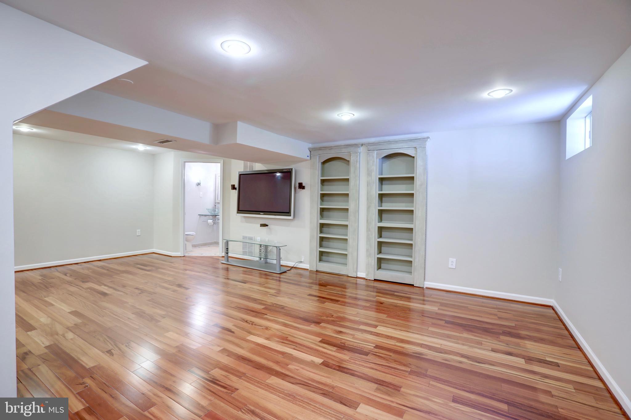 2336 Rosedown Drive Reston, VA 20191 - Photo 21 of 30 BUILT IN BOOKCASES HIDE THE FURNACE & LAUNDRY RM