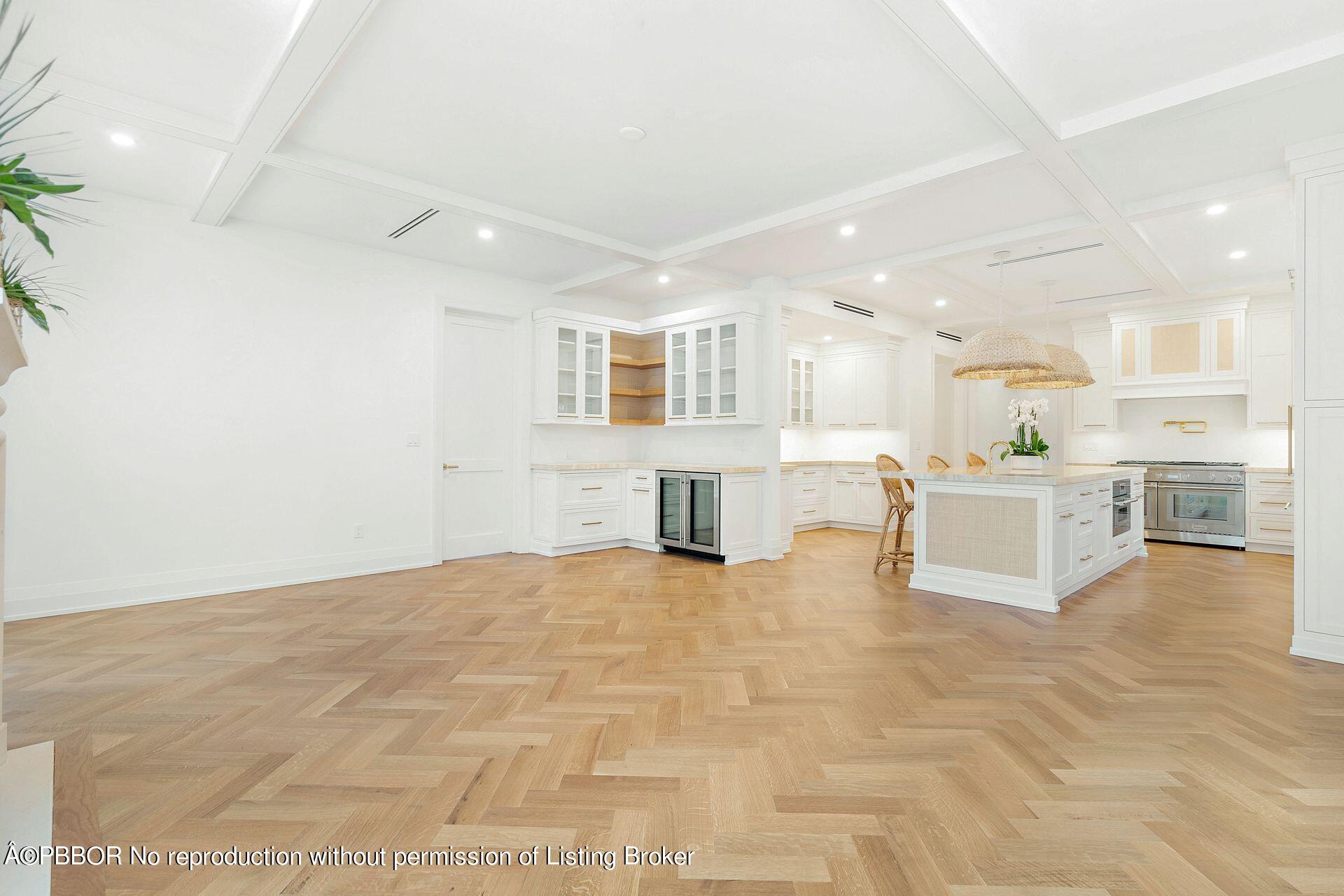 320 Sunset Road West Palm Beach, FL 33401 - Photo 11 of 35 a view of a kitchen with kitchen island a sink wooden floor and counter top space