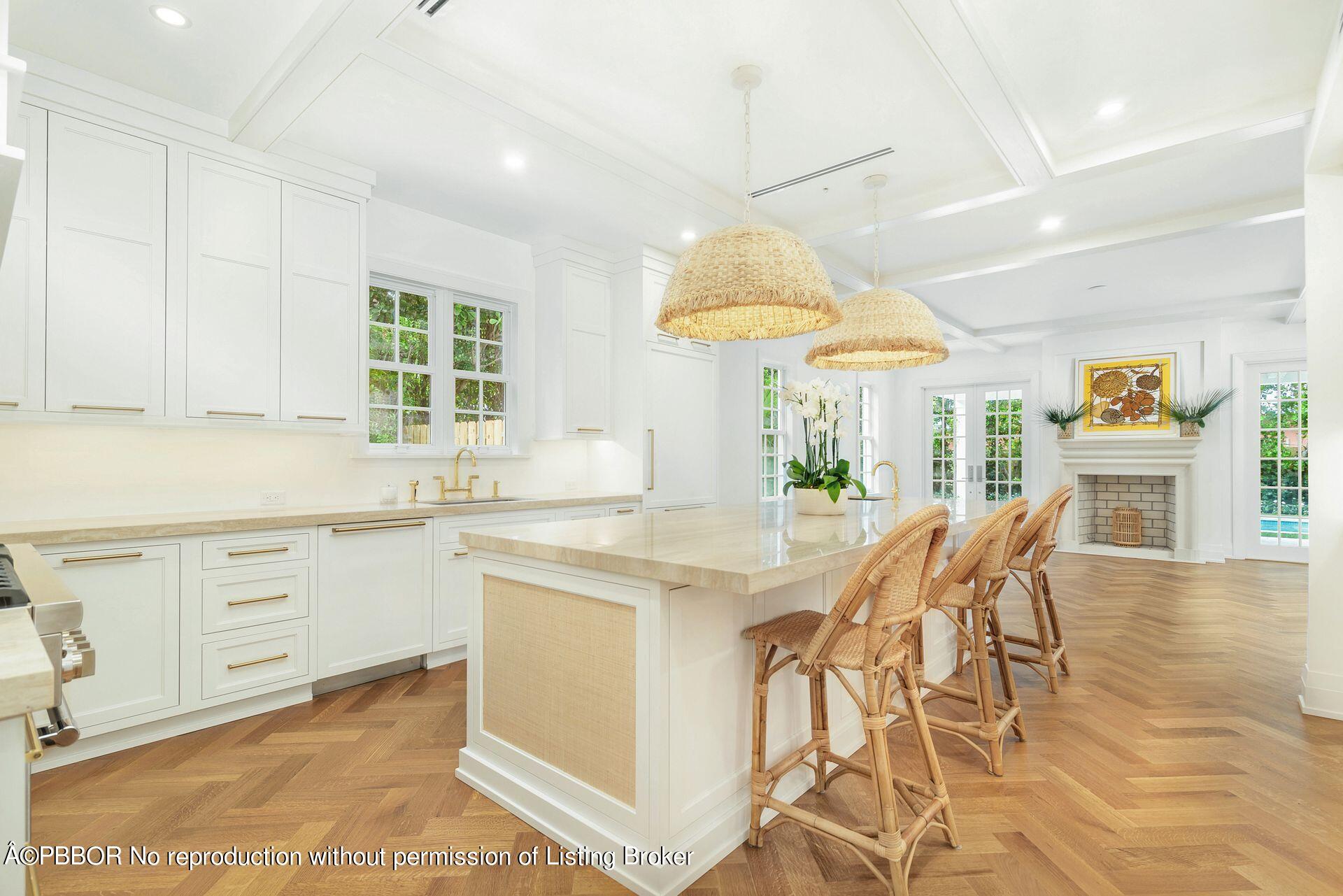 320 Sunset Road West Palm Beach, FL 33401 - Photo 14 of 35 a kitchen with stainless steel appliances a table chairs and white cabinets