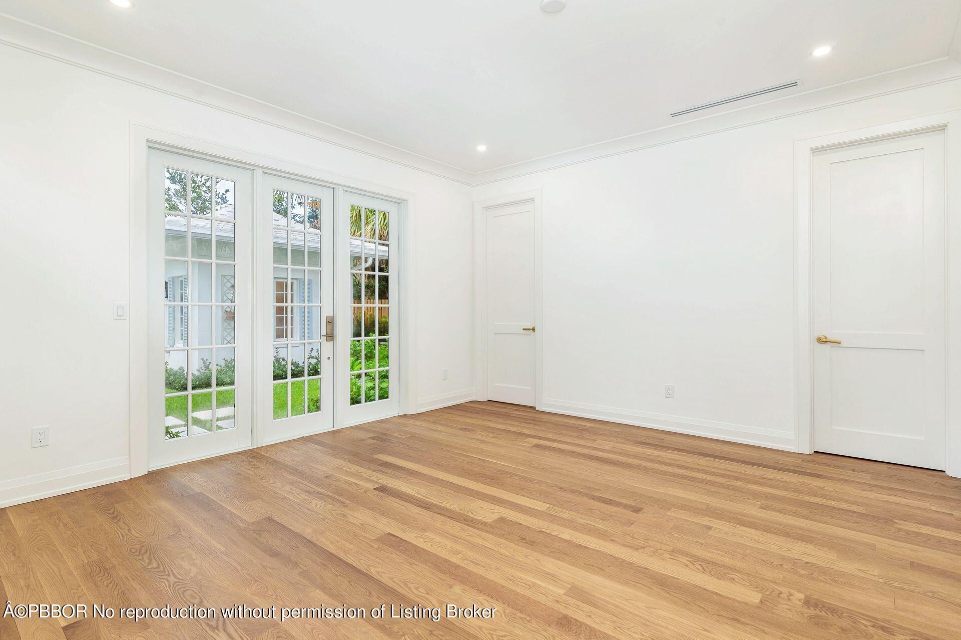 320 Sunset Road West Palm Beach, FL 33401 - Photo 17 of 35 a view of an empty room with wooden floor and a window