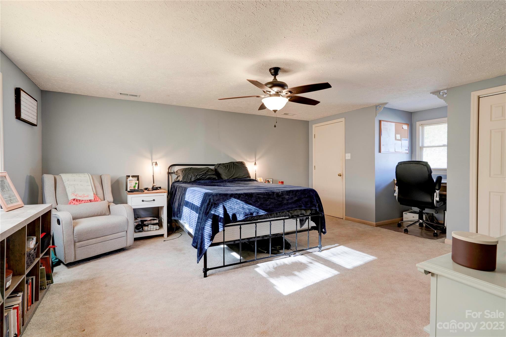 128 Burley's Knob Bostic, NC 28018 - Photo 18 of 19 a bedroom with a bed a couch and a chandelier