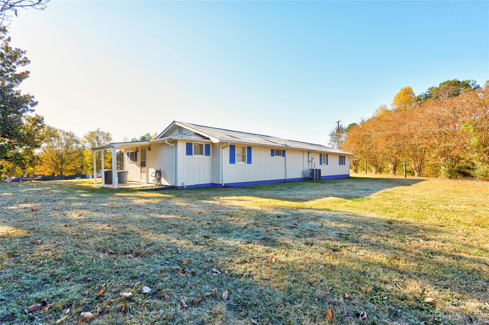 128 Burley's Knob Bostic, NC 28018 - Photo 5 of 19 a backyard of a house with large trees and outdoor seating