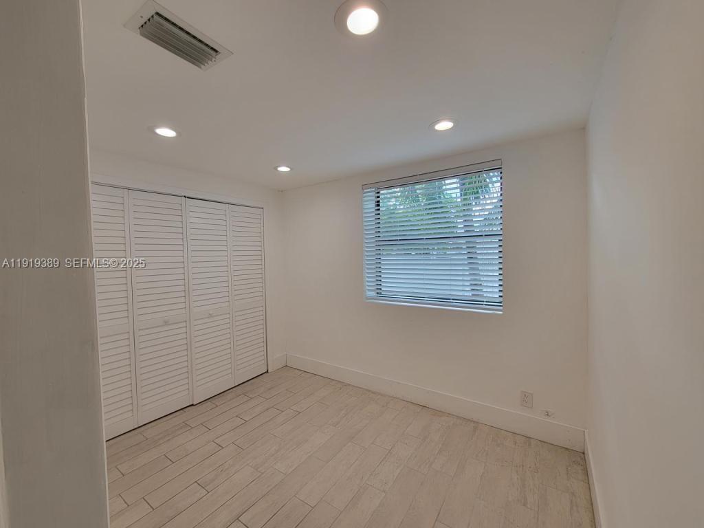 445 Southwest 3rd Street, Unit 1 Miami, FL 33130 - Photo 2 of 11 an empty room with windows