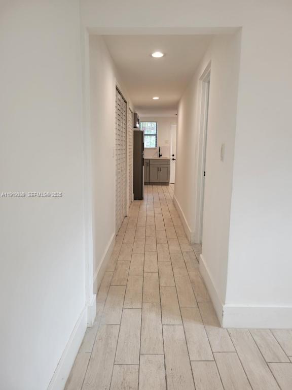 445 Southwest 3rd Street, Unit 1 Miami, FL 33130 - Photo 4 of 11 a view of hallway with a window and a mirror
