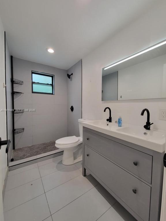 445 Southwest 3rd Street, Unit 1 Miami, FL 33130 - Photo 7 of 11 a bathroom with a toilet a sink and mirror