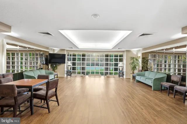 a living room with furniture and a large window with wooden floor