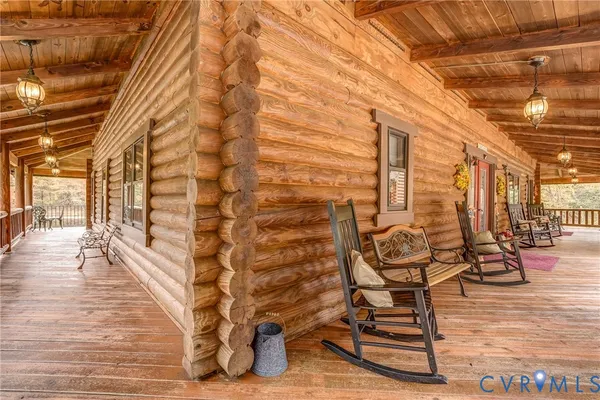 a view of a porch with wooden floor and outdoor space