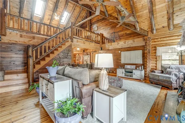 a spacious bedroom with a bed and wooden floor