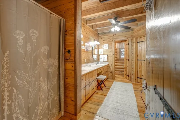 a bathroom with a granite countertop shower and a sink