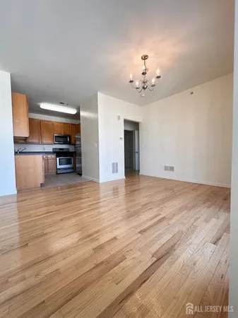 a view of a livingroom with furniture wooden floor and chandelier