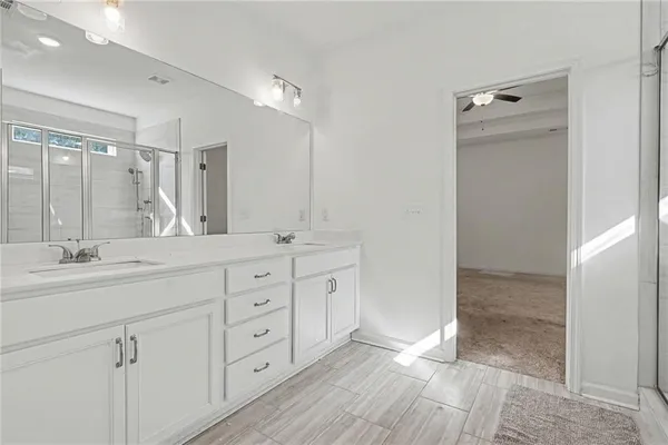 a bathroom with a granite countertop sink mirror and double