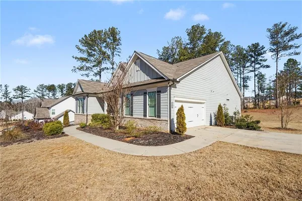 a front view of a house with a yard and chandelier