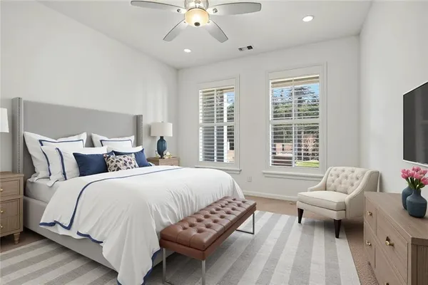 a spacious bedroom with a bed and a couch