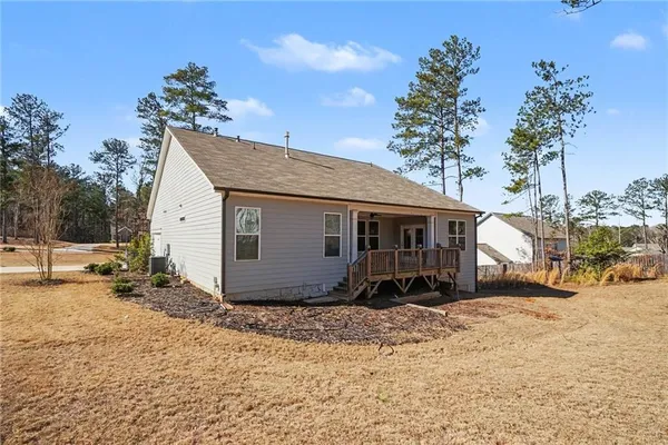 a view of a house with a yard covered in snow