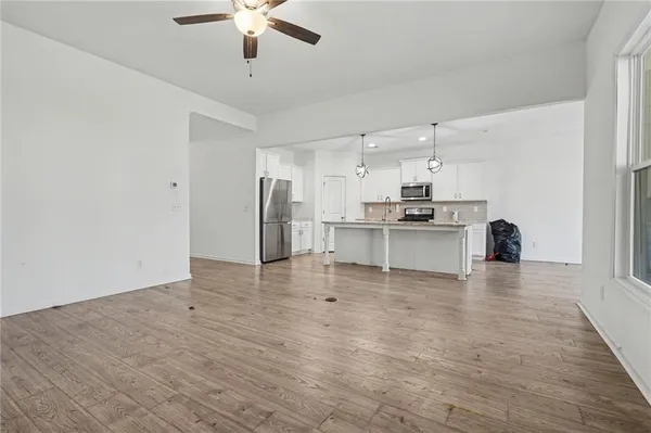 a view of kitchen with refrigerator stove microwave and cabinets