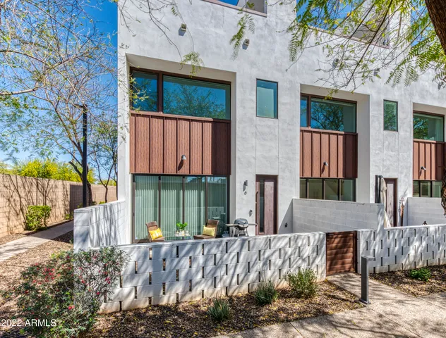 a view of a house with a yard and wooden fence