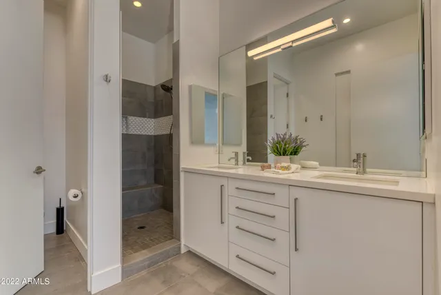 a bathroom with a double vanity sink and mirror