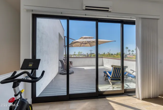 a view of roof deck with seating space and wooden floor