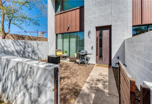 a living room with furniture and a painting on the wall