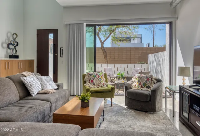 a living room with furniture and a large window