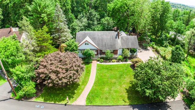 a view of house with yard and green space