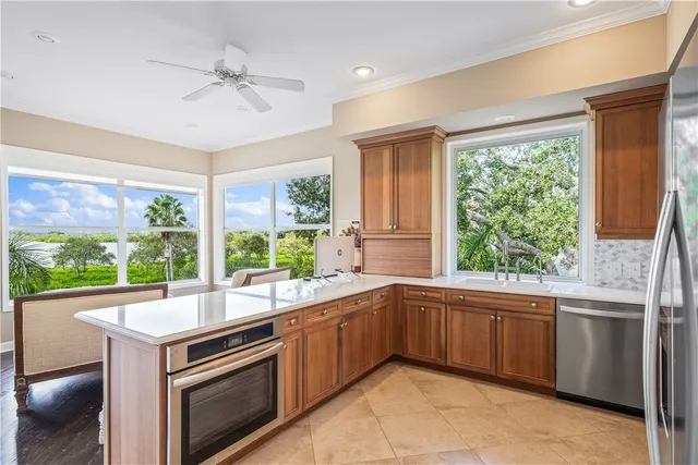 a kitchen with stainless steel appliances granite countertop a refrigerator and a sink