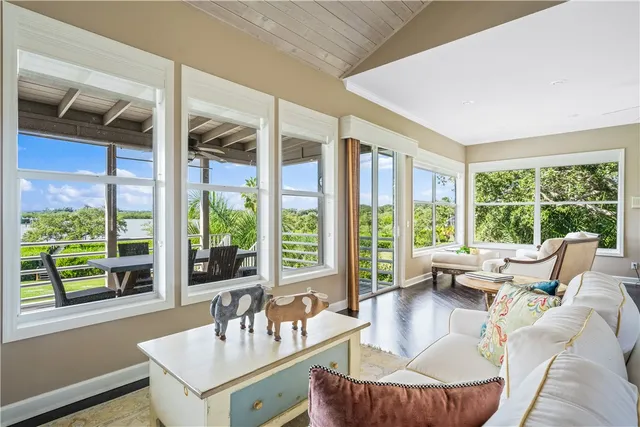 a bedroom with a bed and a large window with outer view