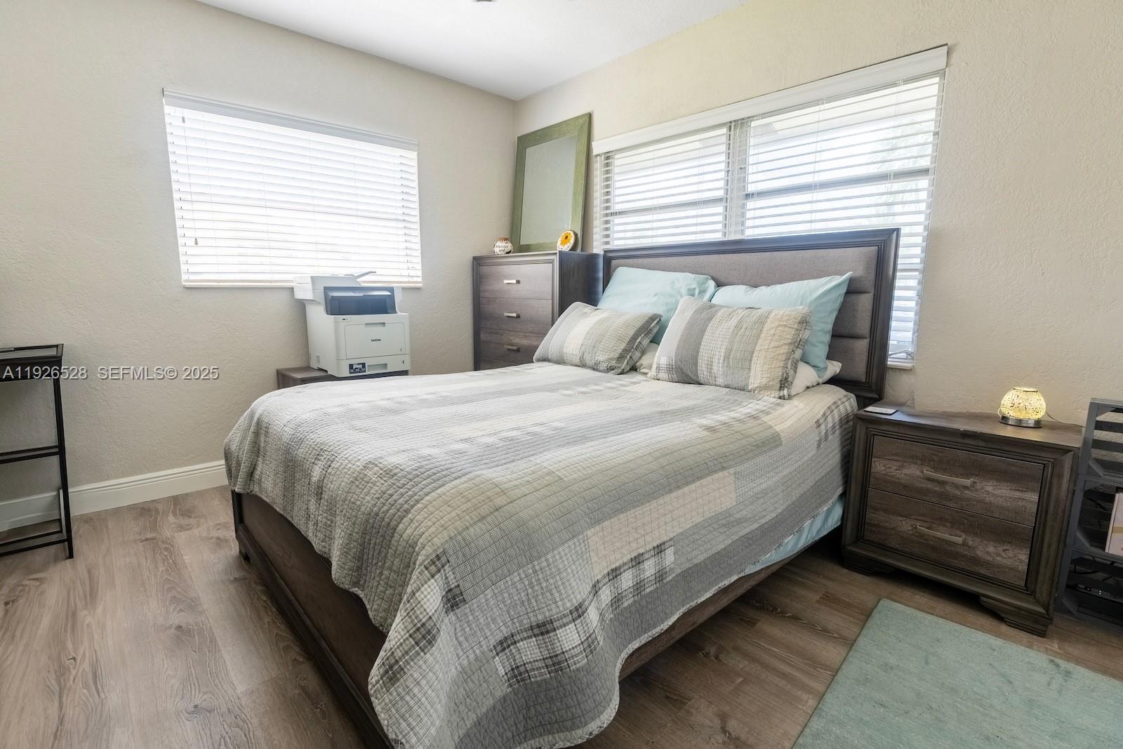7002 Northwest 95th Avenue Tamarac, FL 33321 - Photo 6 of 12 a bedroom with a bed and a window
