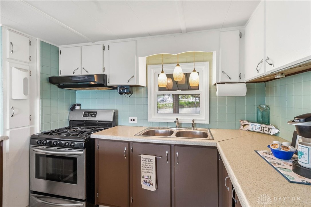 246 North Orchard Island Road Russells Point, OH 43348 - Photo 15 of 43 This cozy kitchen offers a charming window and functional design, perfect for daily living.