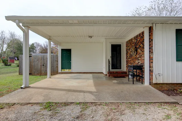 a kitchen with white cabinets and appliances