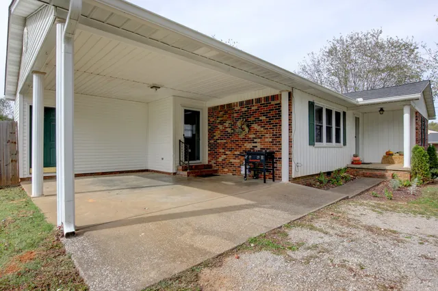 a kitchen with stainless steel appliances white cabinets and wooden floors