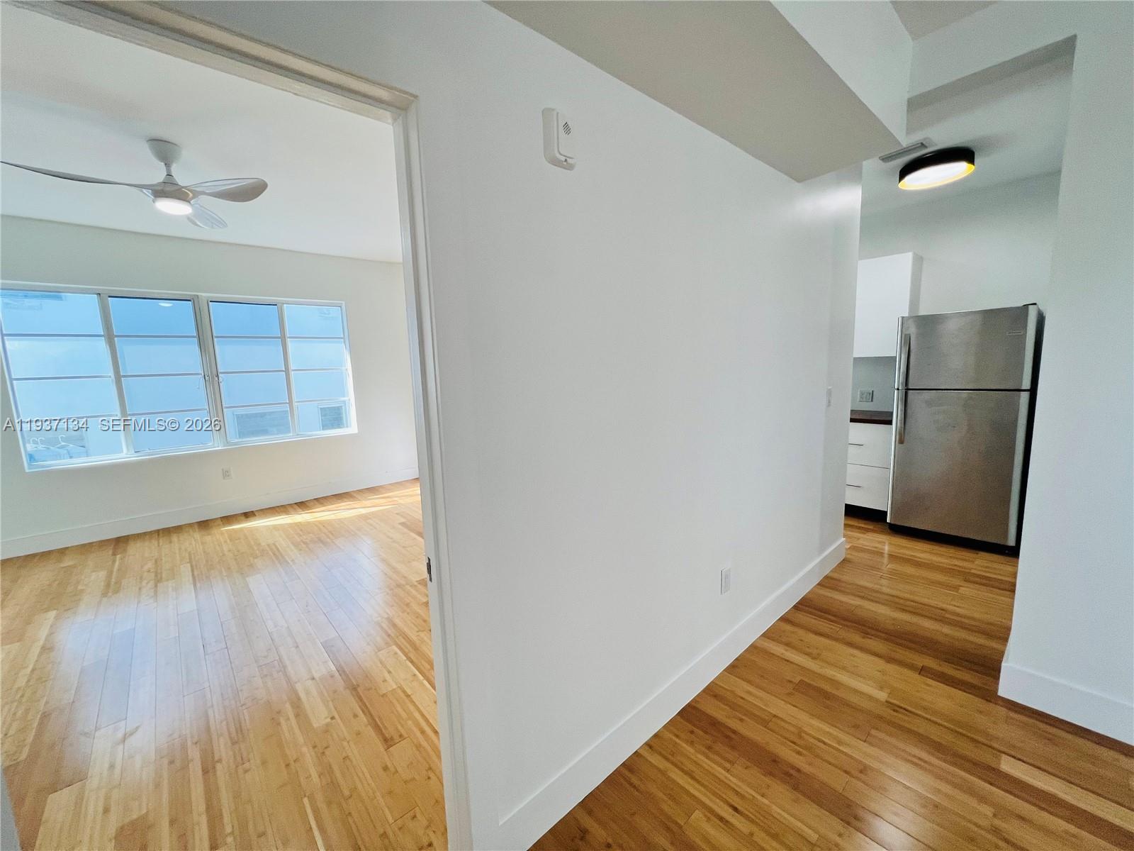 960 Bay Drive, Unit 902 Miami Beach, FL 33141 - Photo 12 of 23 a view of an empty room with wooden floor and a window