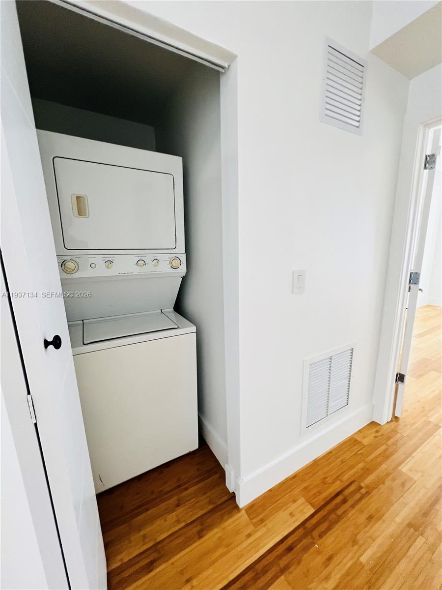 960 Bay Drive, Unit 902 Miami Beach, FL 33141 - Photo 17 of 23 a utility room with wooden floor washer and dryer