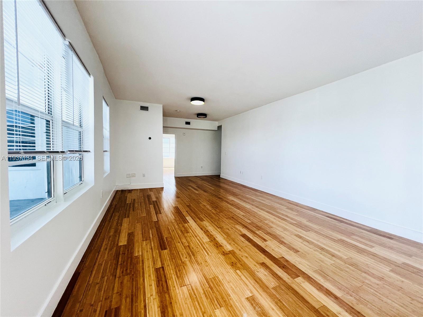 960 Bay Drive, Unit 902 Miami Beach, FL 33141 - Photo 4 of 23 wooden floor in a hall with an entryway