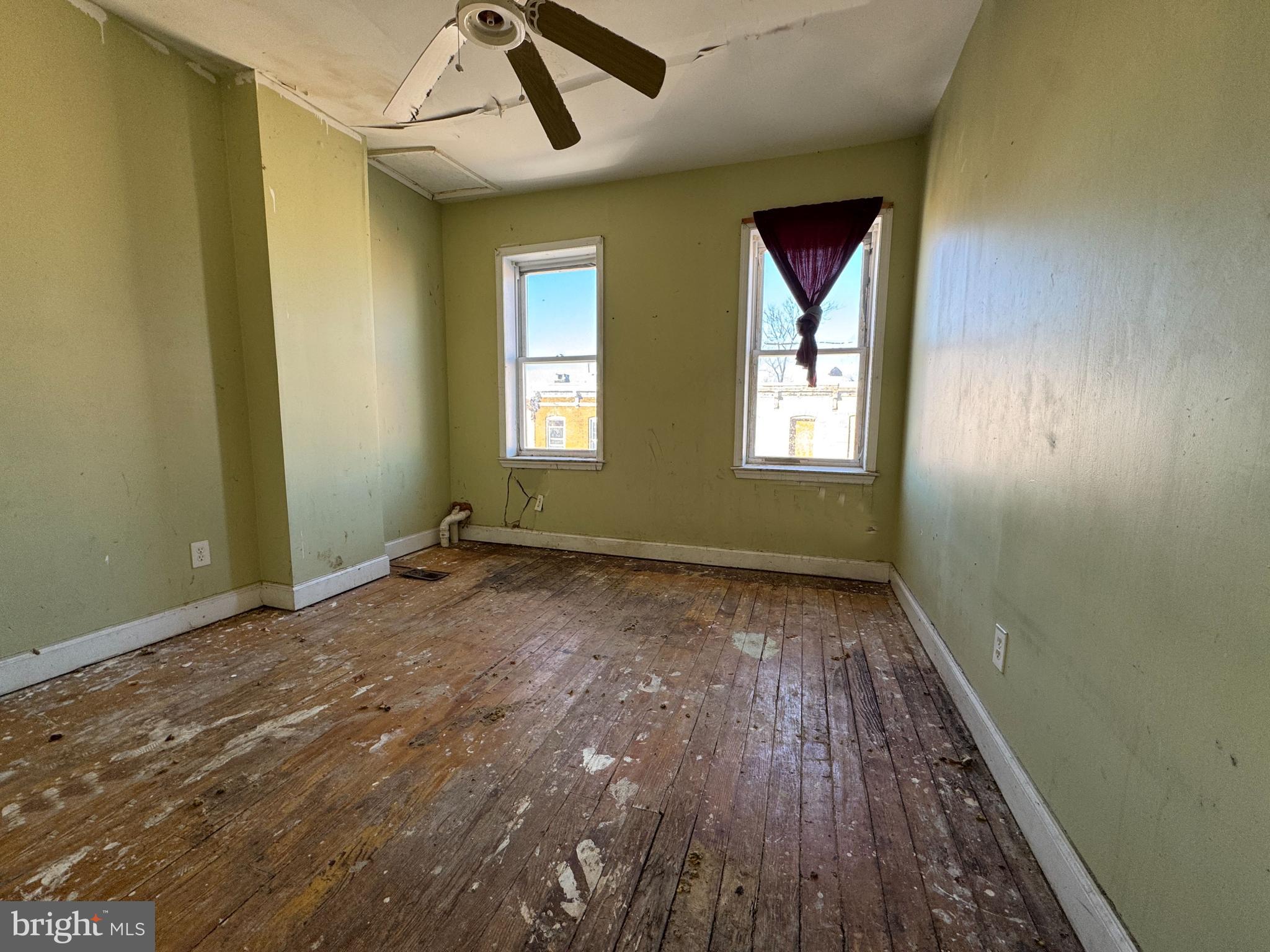 2141 Vine Street Baltimore, MD 21223 - Photo 10 of 15 a view of an empty room with window and wooden floor