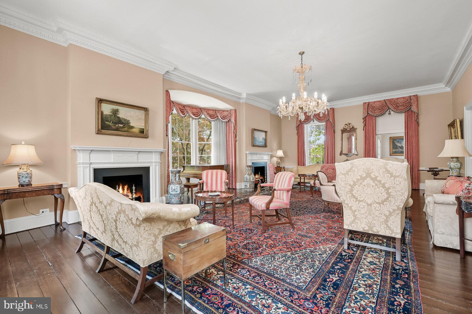 3508 Prospect Street Northwest Washington, DC 20007 - Photo 5 of 39 a living room with furniture a chandelier and a fireplace