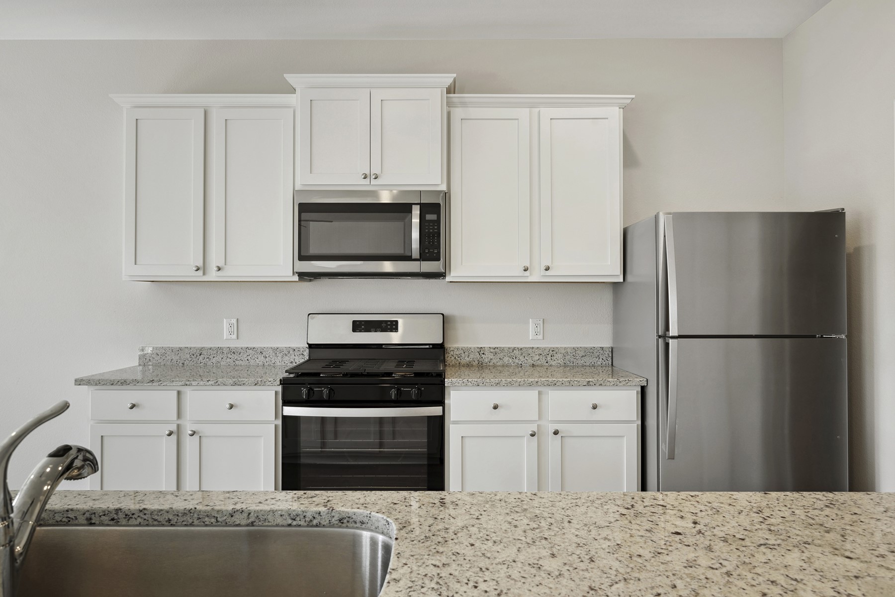 324 Fastboy Lane Waller, TX 77484 - Photo 10 of 13 a kitchen with a refrigerator stove and white cabinets