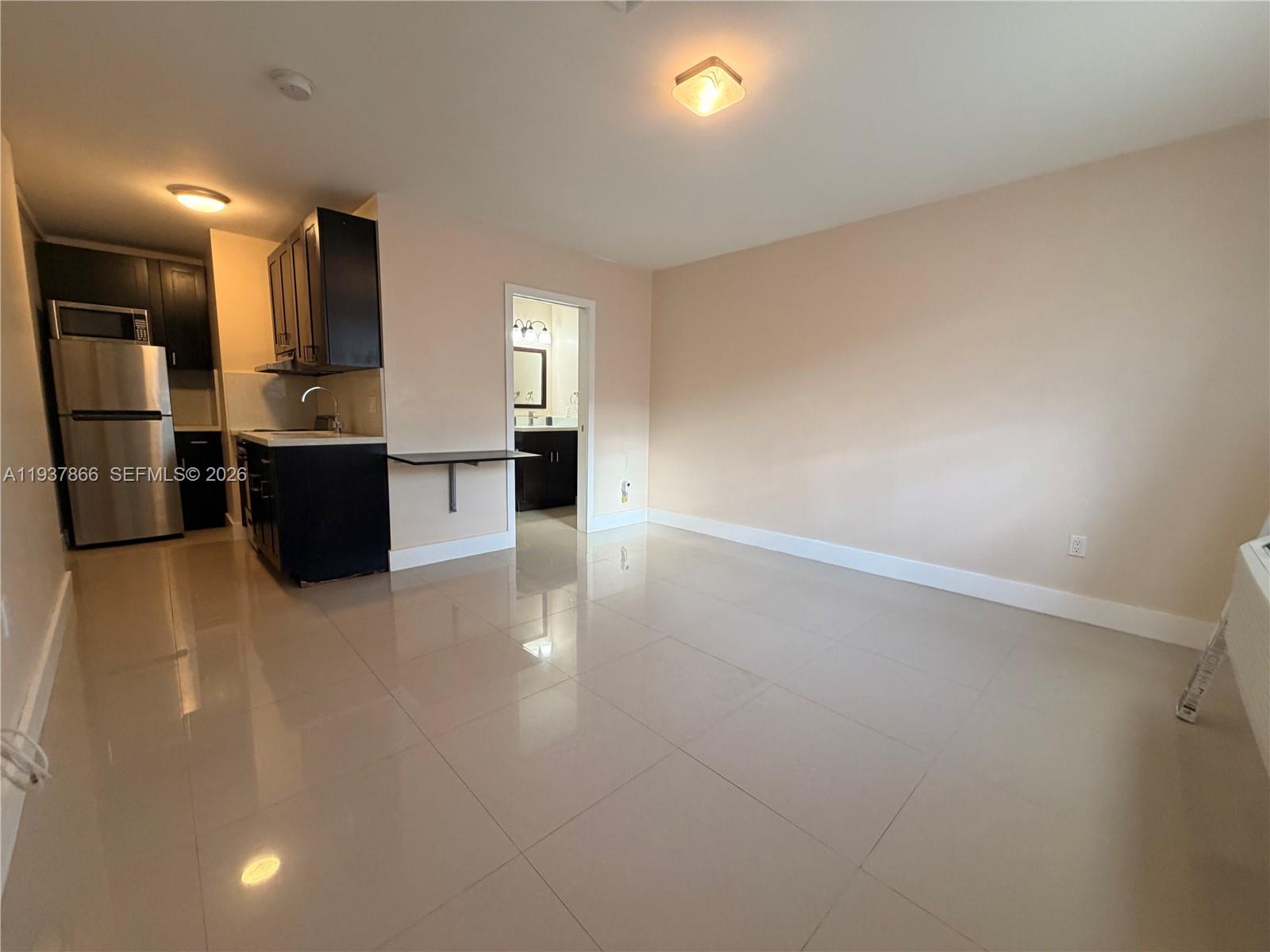 15337 Southwest 62nd Terrace, Unit B Miami, FL 33193 - Photo 1 of 9 a view of a kitchen with a sink and a refrigerator