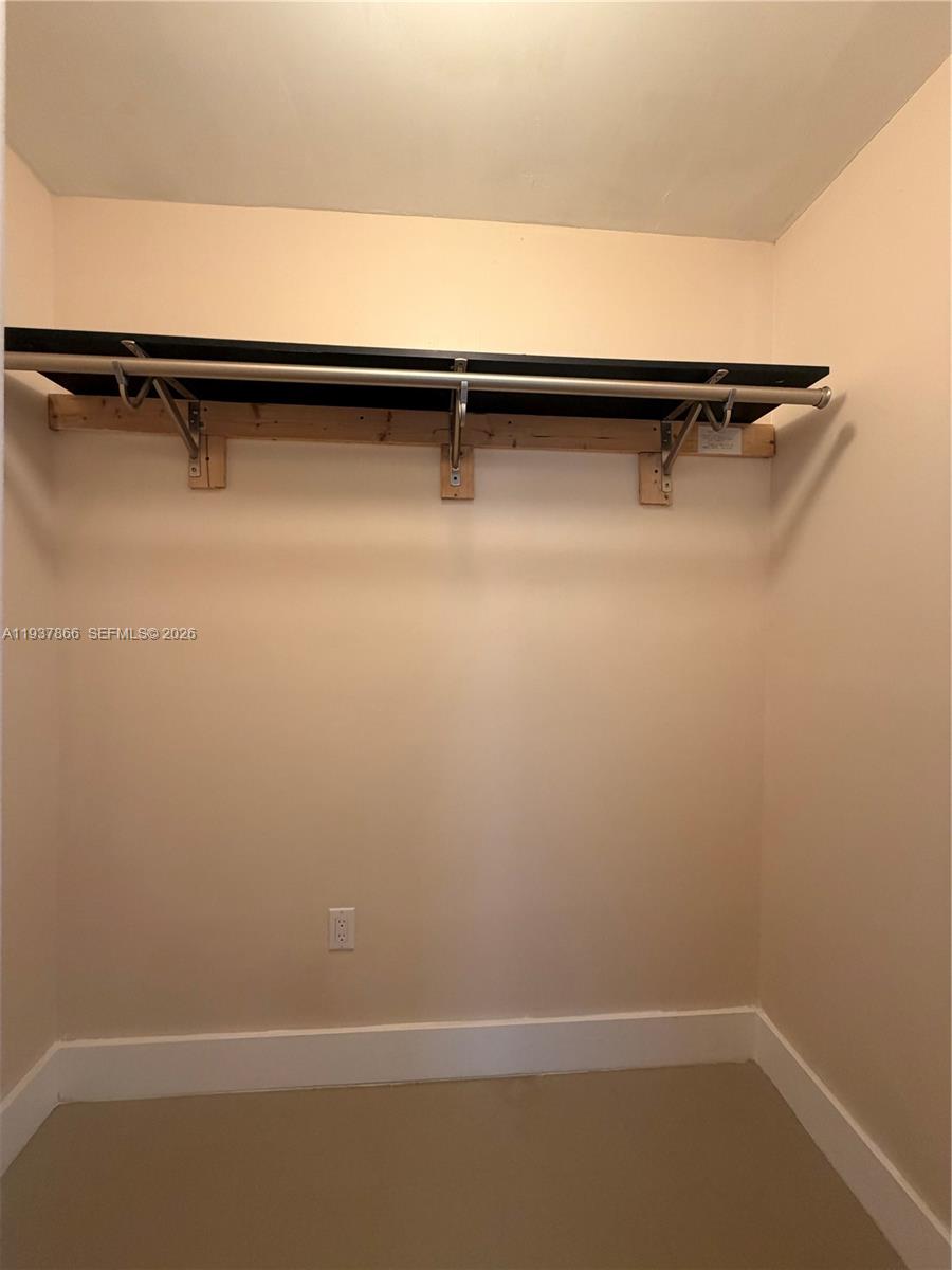 15337 Southwest 62nd Terrace, Unit B Miami, FL 33193 - Photo 7 of 9 a view of a room with racks on the wall