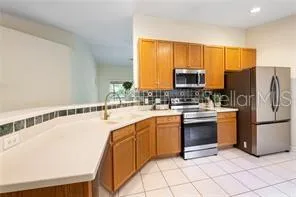 a kitchen with stainless steel appliances granite countertop a stove a sink and a refrigerator