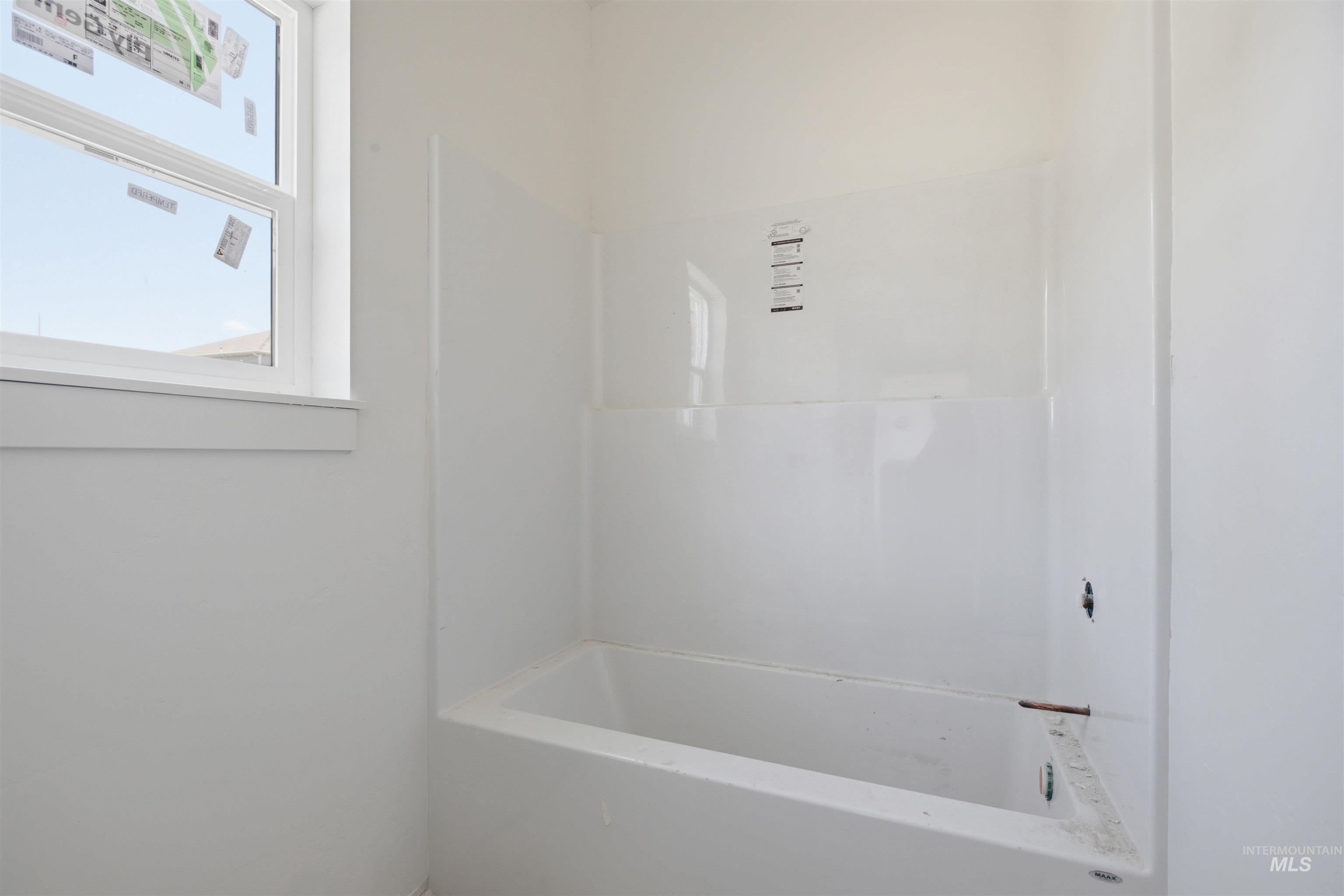 2812 Cyprus Court Moscow, ID 83843 - Photo 7 of 22 Room featuring a window, white interior walls, and gray speckled flooring