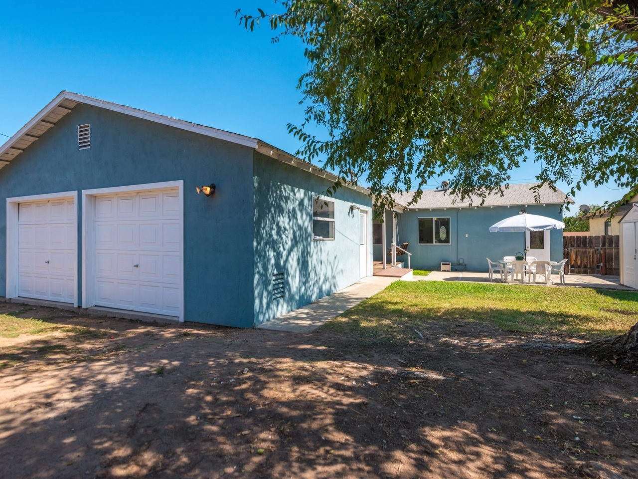 Backyard with Huge Workshop Addition with 2 roll up doors and openers. Accessible from the Easement at the Back of the house.