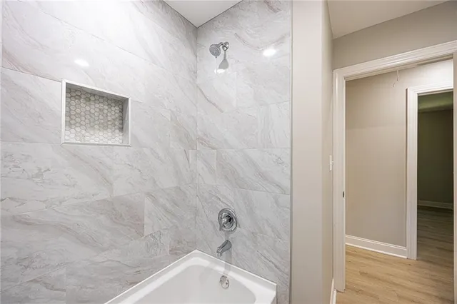 a bathroom with a shower and a bath tub