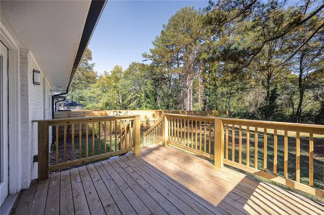 a view of balcony with wooden floor and fence