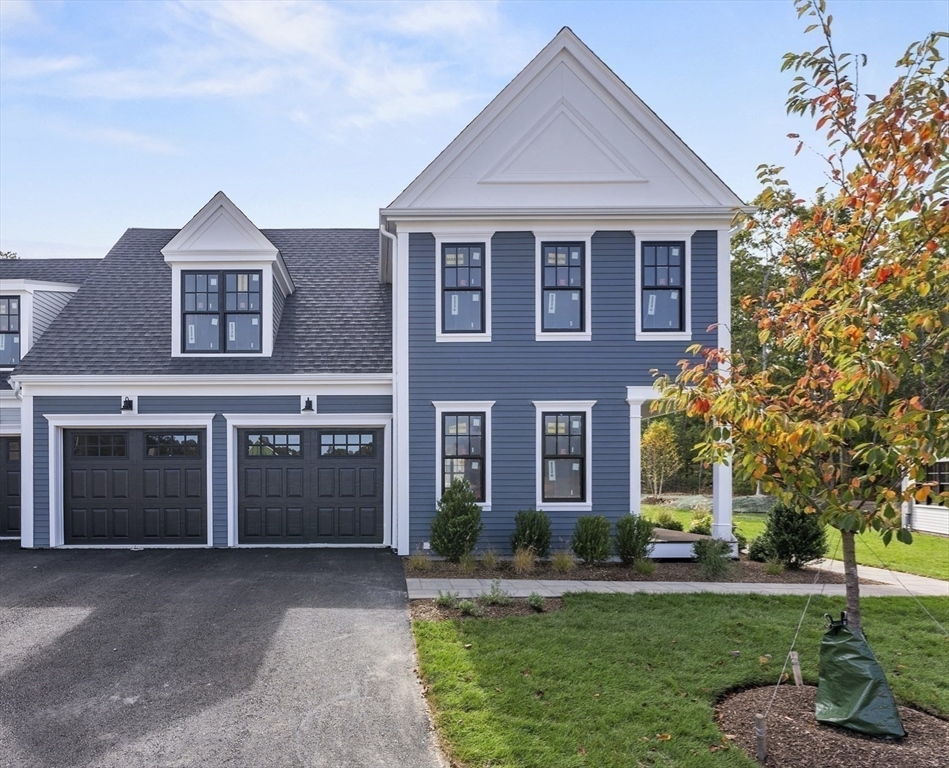 46 Sandwich Road, Unit 26 Plymouth, MA 02360 - Photo 4 of 41 a front view of a house with a yard and garage