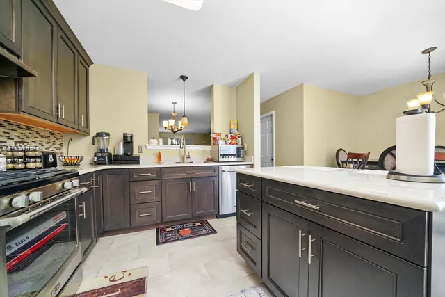 a kitchen with a sink stove and cabinets