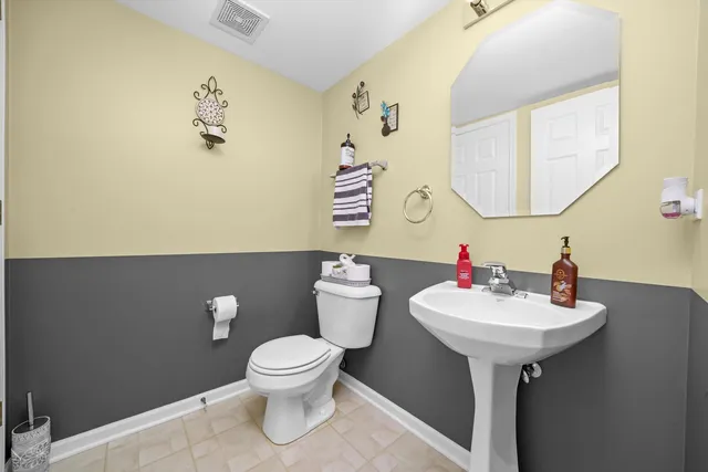 a bathroom with a sink mirror and toilet