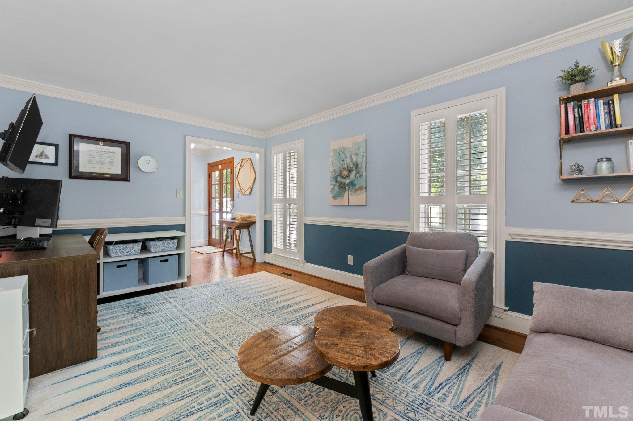 9301 Greenfield Drive Raleigh, NC 27615 - Photo 3 of 48 Living Room off of Foyer with crown molding and chair railing.