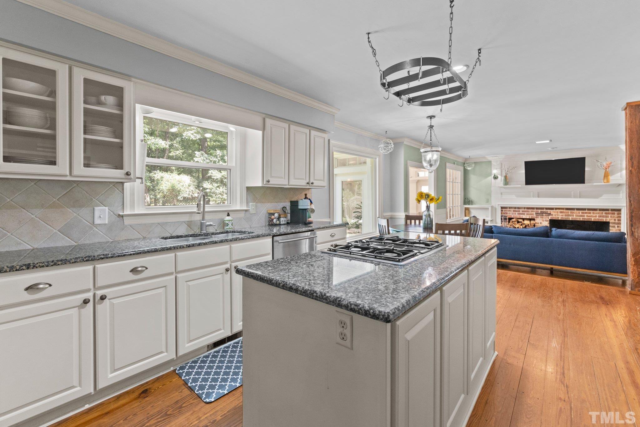 9301 Greenfield Drive Raleigh, NC 27615 - Photo 7 of 48 Stainless steel appliances in Kitchen include wall convection oven, microwave, and dishwasher.